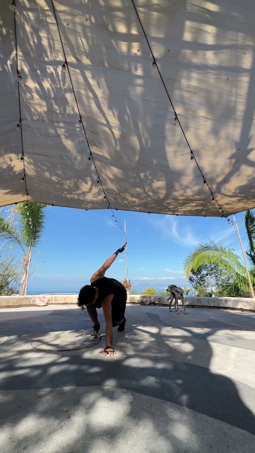 Leg high under a shade sail by the ocean